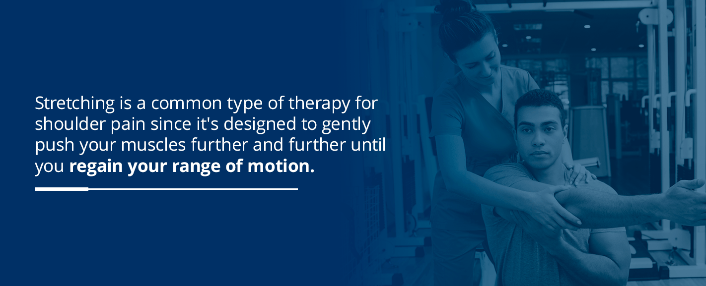 Stretching physical therapist helping man regain range of motion in shoulder