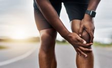 athlete holding knee